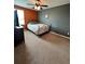 Bedroom featuring ceiling fan, carpeting, and orange and grey accent wall at 1952 Dunn Cove Dr, Apopka, FL 32703