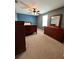 Carpeted bedroom featuring a blue accent wall and wooden furniture at 1952 Dunn Cove Dr, Apopka, FL 32703