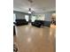 Spacious living room with tile flooring, ceiling fan and comfortable leather seating, perfect for relaxation at 1952 Dunn Cove Dr, Apopka, FL 32703