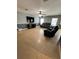 Spacious living room with tile flooring, ceiling fan and comfortable leather seating, perfect for relaxation at 1952 Dunn Cove Dr, Apopka, FL 32703
