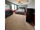 Comfortable main bedroom featuring plush carpeting, ceiling fan, and ample natural light from large windows at 1952 Dunn Cove Dr, Apopka, FL 32703