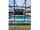 Inviting screened pool featuring clear blue water, fountain feature, and outdoor lighting in a private backyard setting at 1952 Dunn Cove Dr, Apopka, FL 32703