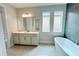 Elegant bathroom with freestanding tub, double vanity, and gray tile at 371 Lady Palm St, Apopka, FL 32703