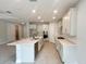 Modern kitchen with island, quartz countertops and stainless steel appliances at 371 Lady Palm St, Apopka, FL 32703
