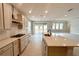 Spacious kitchen with island, stainless steel appliances, and light cabinets at 371 Lady Palm St, Apopka, FL 32703