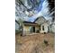View of a large backyard with mature trees and a cozy patio seating area at 6776 Brittany Chase Ct, Orlando, FL 32810