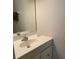 Neutral bathroom featuring a vanity and a large mirror at 6776 Brittany Chase Ct, Orlando, FL 32810