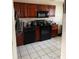 Spacious kitchen with dark cabinetry, black appliances, and tile flooring at 6776 Brittany Chase Ct, Orlando, FL 32810