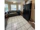 Spacious kitchen with black appliances, ample counter space, and tile flooring at 6776 Brittany Chase Ct, Orlando, FL 32810