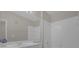 Bright bathroom with white tile, vanity, and shower-tub combo at 14304 Fredricksburg Dr # 420, Orlando, FL 32837