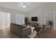 Open living room with vaulted ceiling, ceiling fan, lanai access, neutral decor, and luxury vinyl floors at 14304 Fredricksburg Dr # 420, Orlando, FL 32837