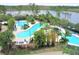 Aerial view of resort pool area with lush tropical landscaping and lake view at 14501 Grove Resort Ave # 1332, Winter Garden, FL 34787