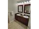 Double sink bathroom vanity with tile floors and granite countertop at 14501 Grove Resort Ave # 1332, Winter Garden, FL 34787