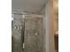 Shower featuring neutral-toned tile and clear glass doors at 14501 Grove Resort Ave # 1332, Winter Garden, FL 34787