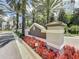 The Grove Resort & Spa sign surrounded by flowers and palm trees offers a warm welcome at 14501 Grove Resort Ave # 1332, Winter Garden, FL 34787