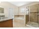 Bathroom with granite countertop and walk-in shower at 2871 Sandy Cay St, Clermont, FL 34711