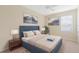 Bedroom with a blue headboard and window blinds at 2871 Sandy Cay St, Clermont, FL 34711