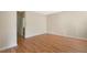 Spacious bedroom with hardwood floors and access to a hallway at 2871 Sandy Cay St, Clermont, FL 34711