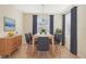 Dining room with light wood table and six gray chairs at 2871 Sandy Cay St, Clermont, FL 34711