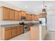 Bright kitchen featuring wood cabinets, granite counters, and stainless steel appliances at 2871 Sandy Cay St, Clermont, FL 34711