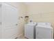 Laundry room with washer, dryer, and shelving at 2871 Sandy Cay St, Clermont, FL 34711