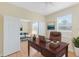 Home office with a wooden desk and view into another room at 2871 Sandy Cay St, Clermont, FL 34711