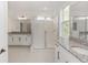 Bathroom features a glass enclosed shower, granite countertop, and white cabinets at 5648 Green Arrow Pl, Sanford, FL 32773