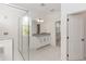 Bathroom features a glass shower enclosure, granite countertop, and white cabinets at 5648 Green Arrow Pl, Sanford, FL 32773