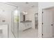 Modern bathroom featuring a glass-enclosed shower, granite countertop vanity, and neutral tile flooring at 5648 Green Arrow Pl, Sanford, FL 32773