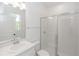 Bright bathroom featuring a glass shower, single vanity, and white tile flooring at 5648 Green Arrow Pl, Sanford, FL 32773