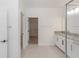 Bathroom features a walk-in closet, granite countertop, and white cabinets at 5648 Green Arrow Pl, Sanford, FL 32773