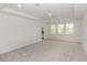 Spacious bedroom with neutral paint, carpet floors, tray ceiling, and bright windows at 5648 Green Arrow Pl, Sanford, FL 32773