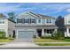 Charming two-story home with a brick driveway, gray exterior, shutters, and a well-maintained front yard at 5648 Green Arrow Pl, Sanford, FL 32773