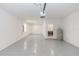 Spacious two car garage with speckled flooring, laundry area, and a utility sink at 5648 Green Arrow Pl, Sanford, FL 32773