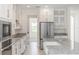 Modern kitchen with stainless steel appliances, a center island, and white cabinetry at 5648 Green Arrow Pl, Sanford, FL 32773