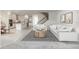 Open-concept living area seamlessly connected to a modern kitchen and staircase to the upper level at 5648 Green Arrow Pl, Sanford, FL 32773