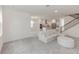 Spacious living room with open layout to kitchen and staircase, with abundant natural light at 5648 Green Arrow Pl, Sanford, FL 32773