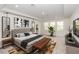 Tastefully decorated bedroom featuring an upholstered bed and a sitting area by bright windows at 5648 Green Arrow Pl, Sanford, FL 32773