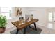 Bright home office with a large wooden desk, neutral walls, and carpeted flooring at 5648 Green Arrow Pl, Sanford, FL 32773