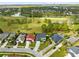 Aerial view of a property with a long driveway, mature landscaping and a tile roof at 2815 Crane Trace Cir, Orlando, FL 32837