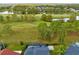 Aerial view of a well-maintained home that backs onto a lush green golf course and lake at 2815 Crane Trace Cir, Orlando, FL 32837