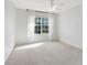 Clean bedroom with a large window, neutral carpet, and ceiling fan at 2815 Crane Trace Cir, Orlando, FL 32837