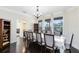 Elegant dining room with dark wood floors, large windows, and sophisticated chandelier lighting at 2815 Crane Trace Cir, Orlando, FL 32837
