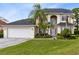 Well-maintained home with a brick paved driveway, 2-car garage, and mature tropical landscaping at 2815 Crane Trace Cir, Orlando, FL 32837