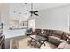 Open-concept living room with hardwood floors, sofa, leading to the breakfast nook and kitchen at 2815 Crane Trace Cir, Orlando, FL 32837