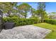 Outdoor stone patio with a grill, perfect for entertaining in this well-maintained backyard at 2815 Crane Trace Cir, Orlando, FL 32837