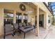 Covered patio with outdoor seating, fan, and access to the backyard at 2815 Crane Trace Cir, Orlando, FL 32837