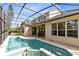A luxurious screened-in pool and patio offer a private oasis in this gorgeous home at 2815 Crane Trace Cir, Orlando, FL 32837