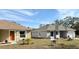 Front yard of two single-story homes with green grass and blue skies at 6921 Central Ave, Mulberry, FL 33860