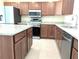 Kitchen featuring stainless steel appliances, granite countertops, and wood cabinets at 6921 Central Ave, Mulberry, FL 33860